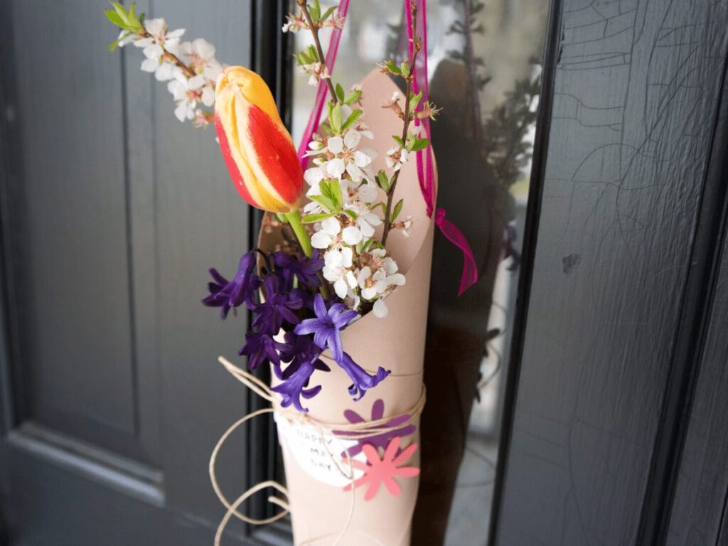 Flower basket hanging on front door as part of May Day celebration. 