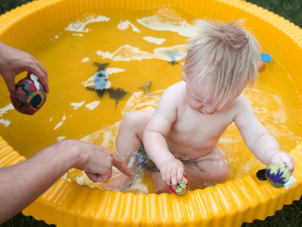 small boy playing in pool-  best outdoor toys