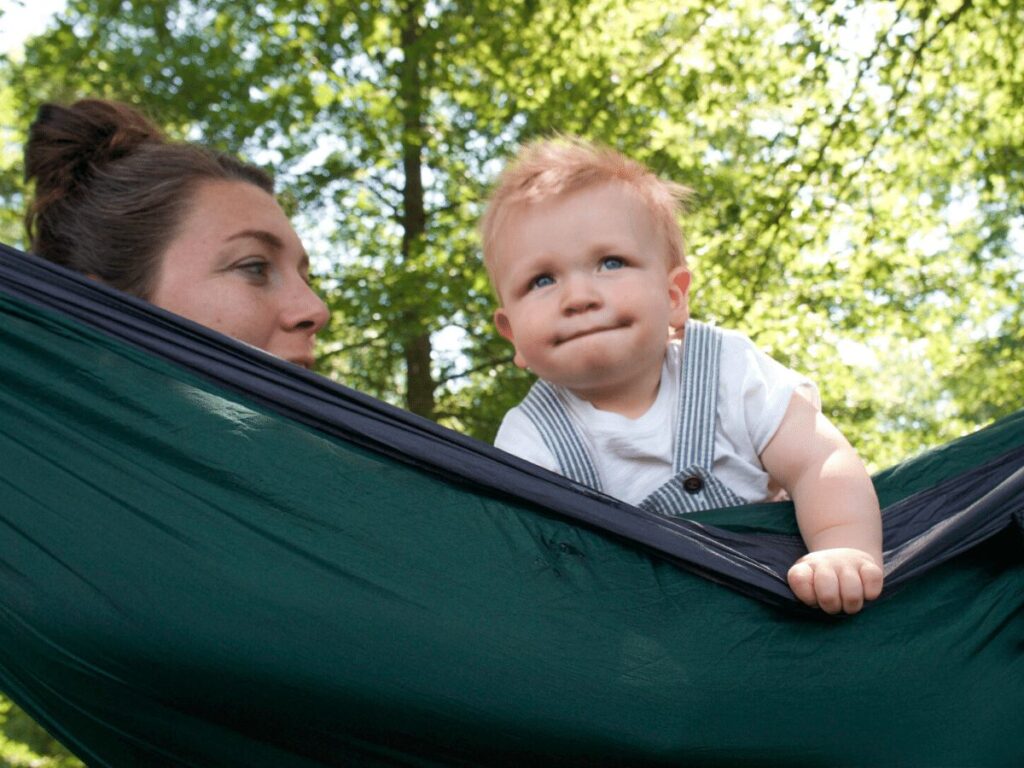 Mom and small boy peeking over the edge of a hammock- summer bucket list