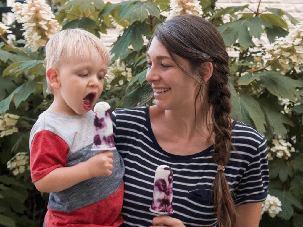 Mom and small boy eating popsicles- summer bucket list