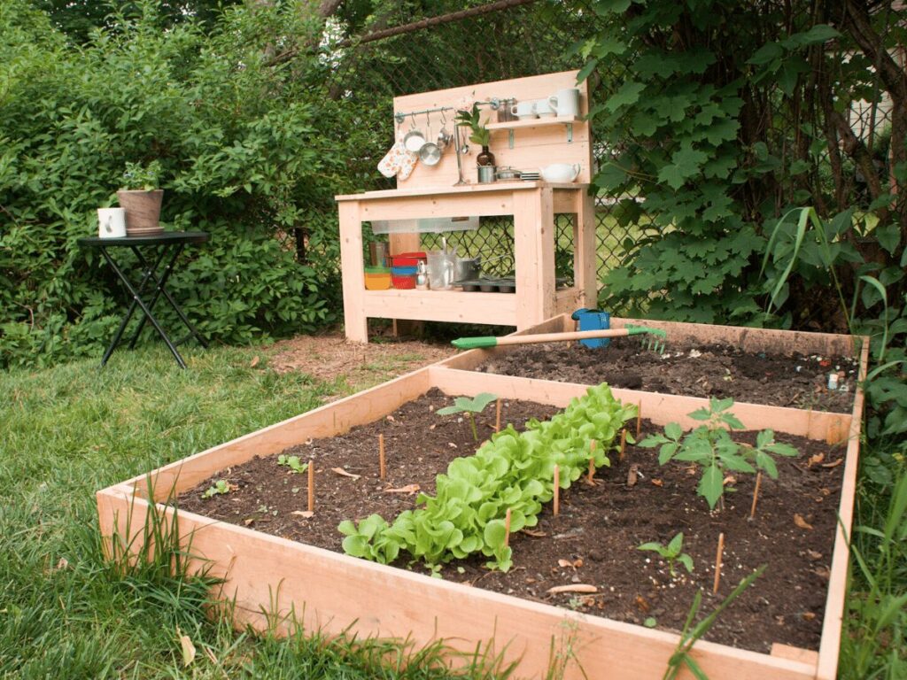 small garden in front of mud kitchen