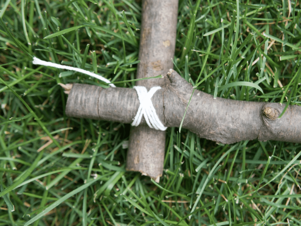 Nature weaving-  close up of corner of branch frame tied together with string
