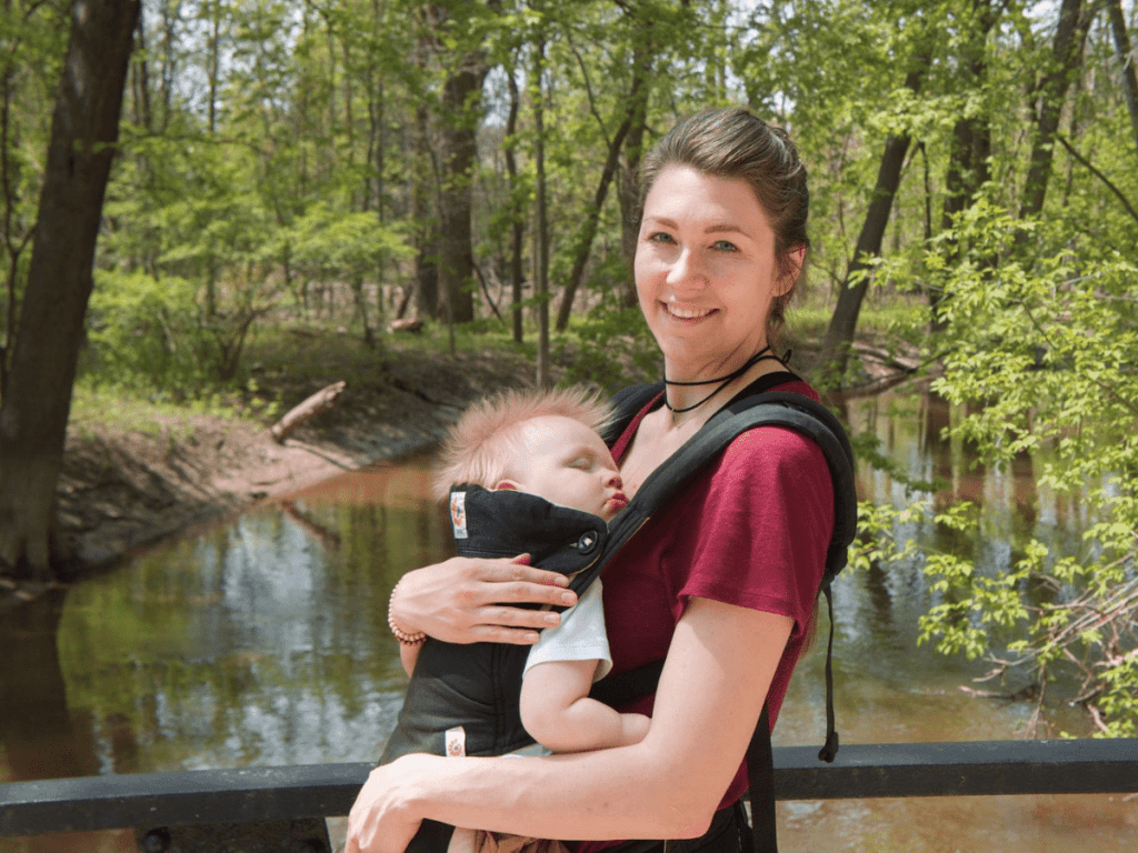 Mom wearing sleeping boy in baby carrier-outdoor gear for babies