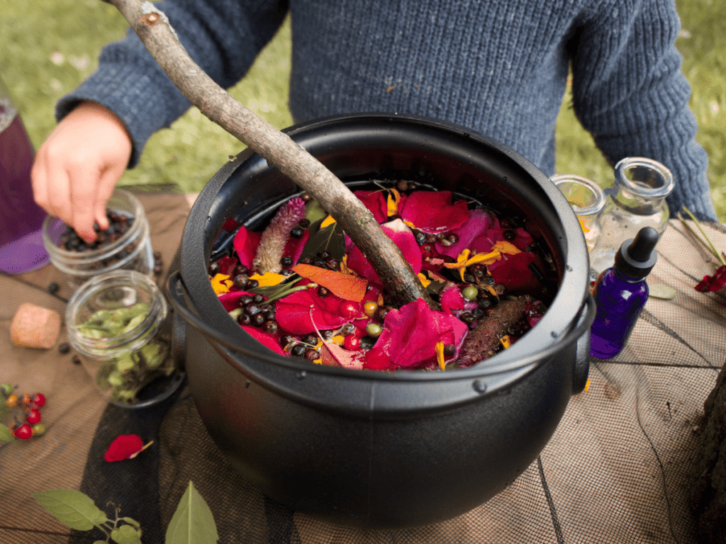 halloween activities for kids, cauldron filled with flower petals and other nature items