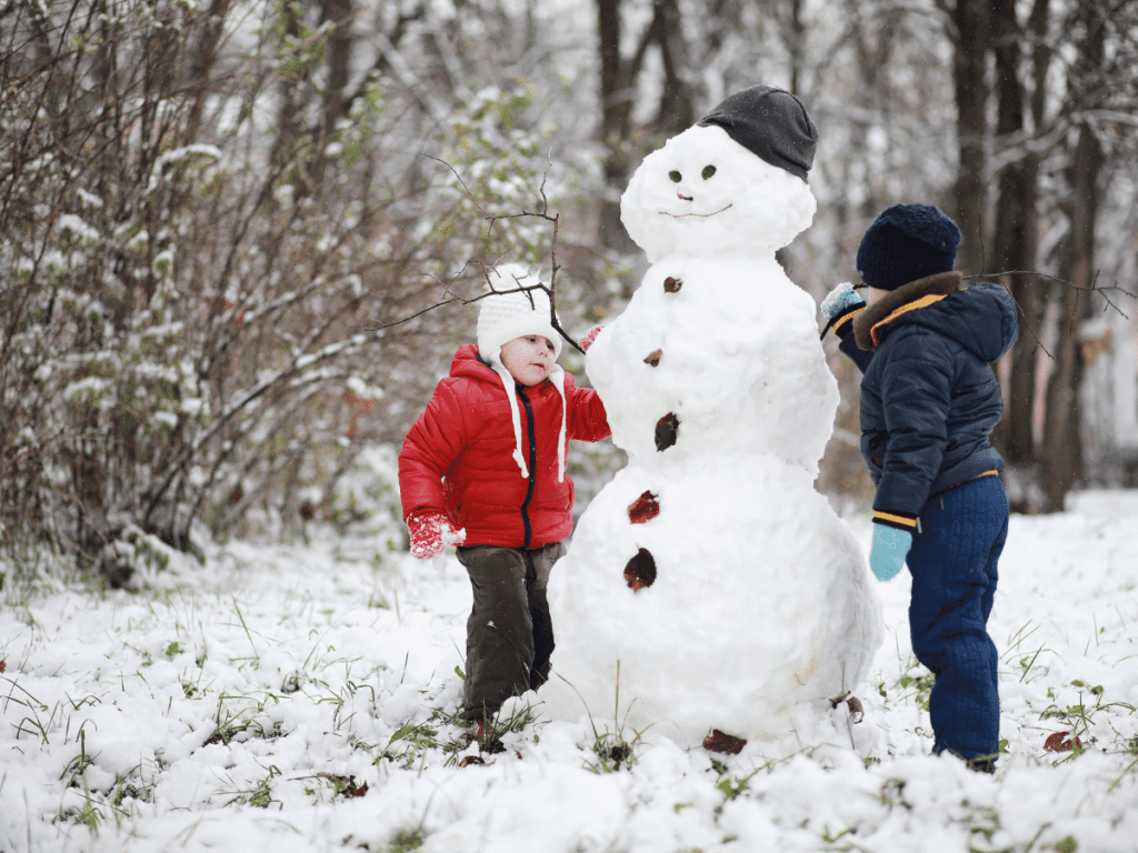 children building a snowman-outdoor winter activities