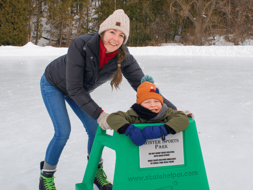 mom and small boy on ice skating rink