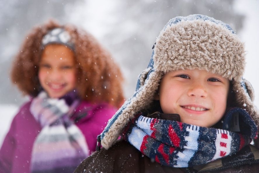 close up of child's face while bundled up outside in snow