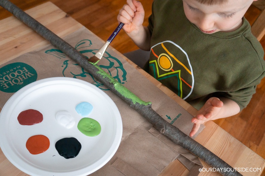 boy painting diy walking stick