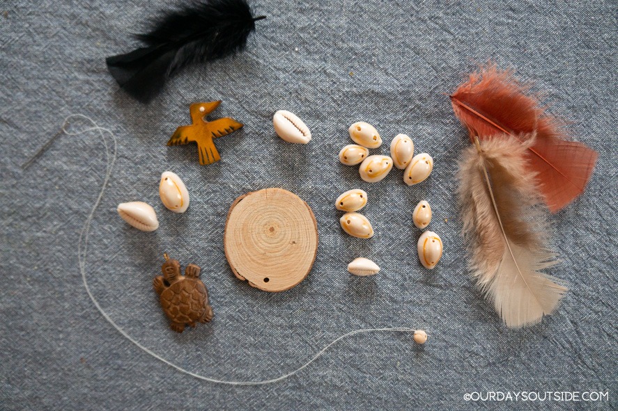 assortment of shells, beads, and feathers