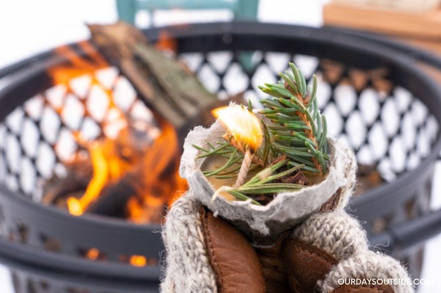 close up of DIY fire starters being held up in front of fire