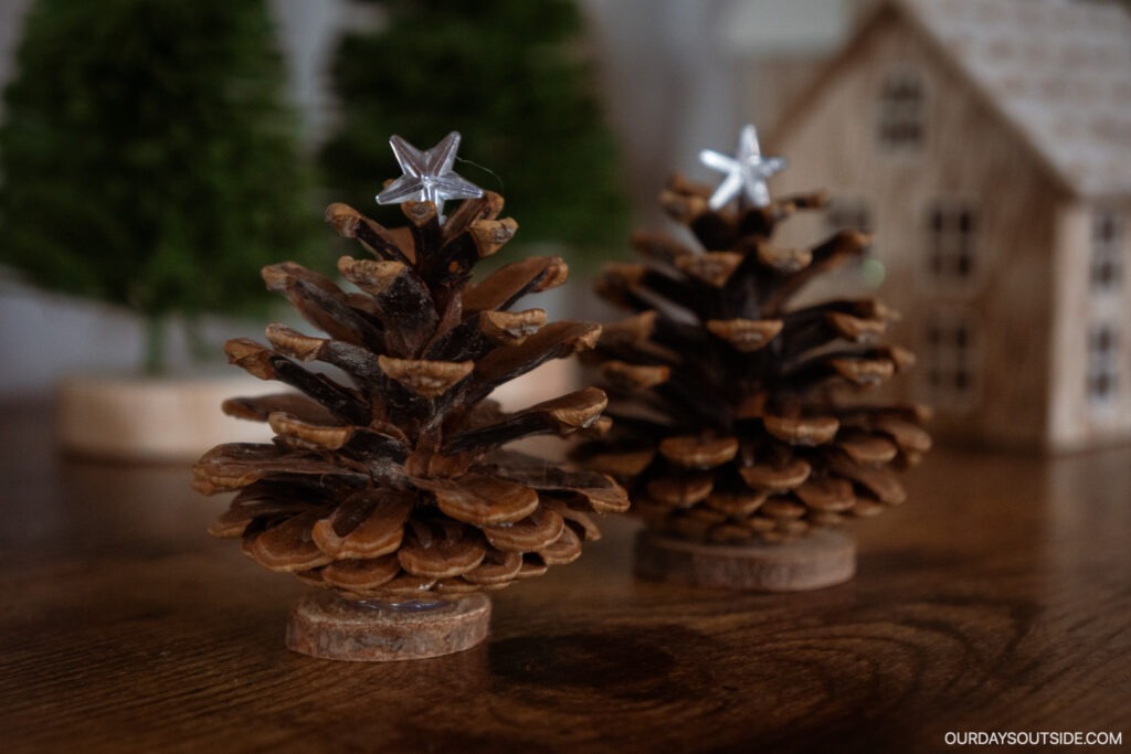 diy christmas crafts: pinecones standing up with star on top