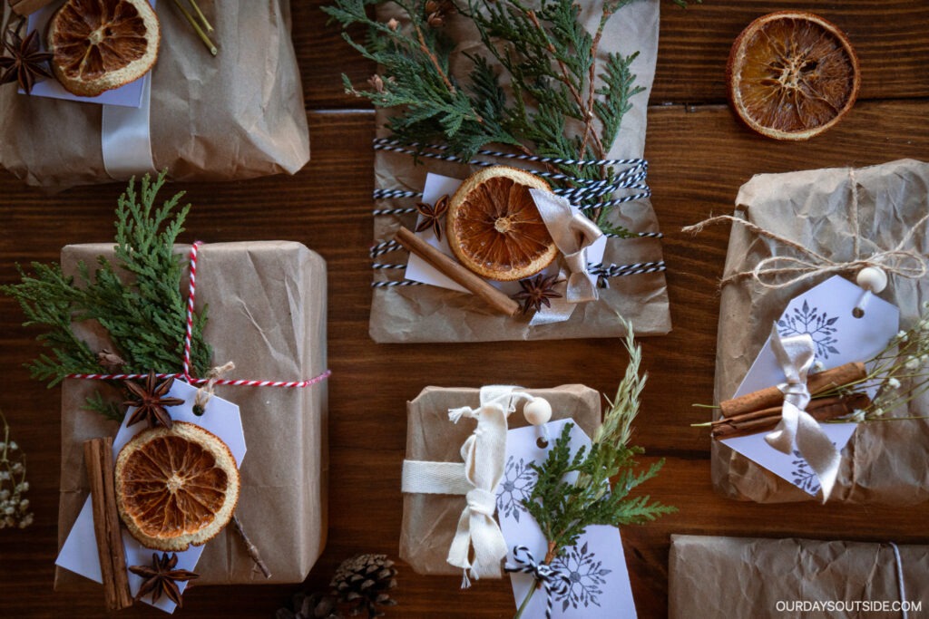 Christmas gift wrapping ideas- brown paper packages covered with greenery, oranges slices, and other nature items.