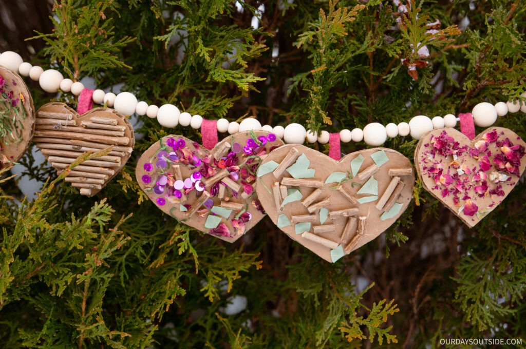 valentine craft for kids- nardboard hearts with rose petals and other nature glued on
