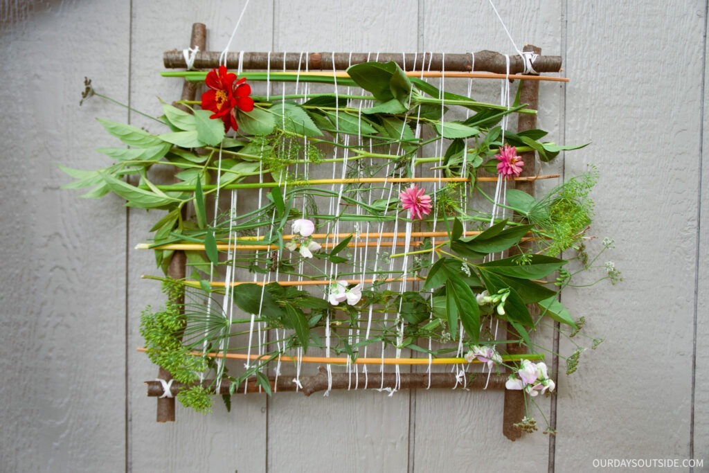 wood frame with pieces of nature woven in middle - summer camp activities craft idea