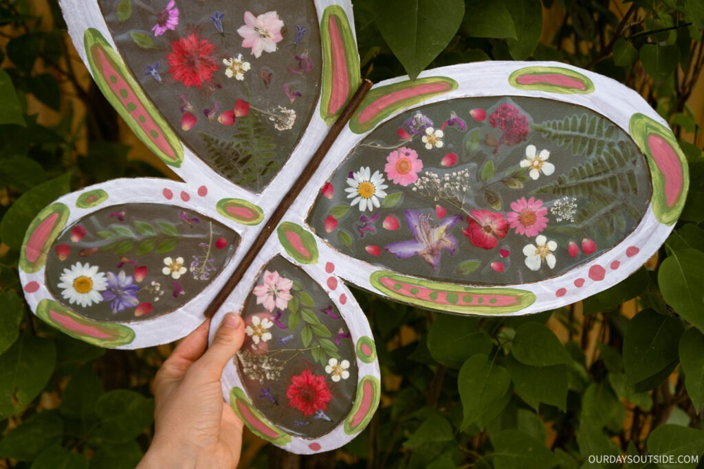diy butterfly wings made out of cardboard and pressed flowers on contact paper.