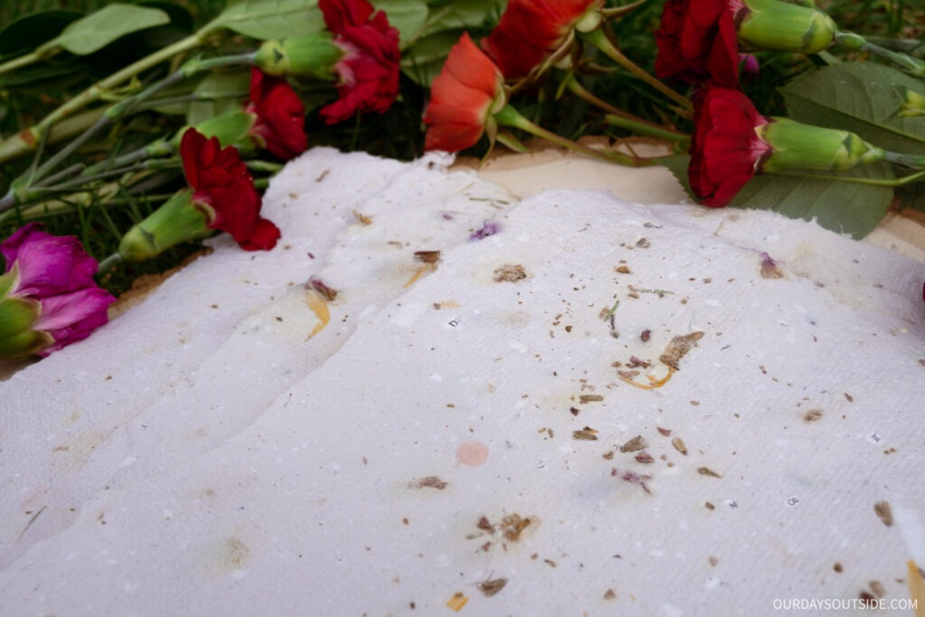 Close up of homemade floral paper made from recycled paper scraps and flower petals