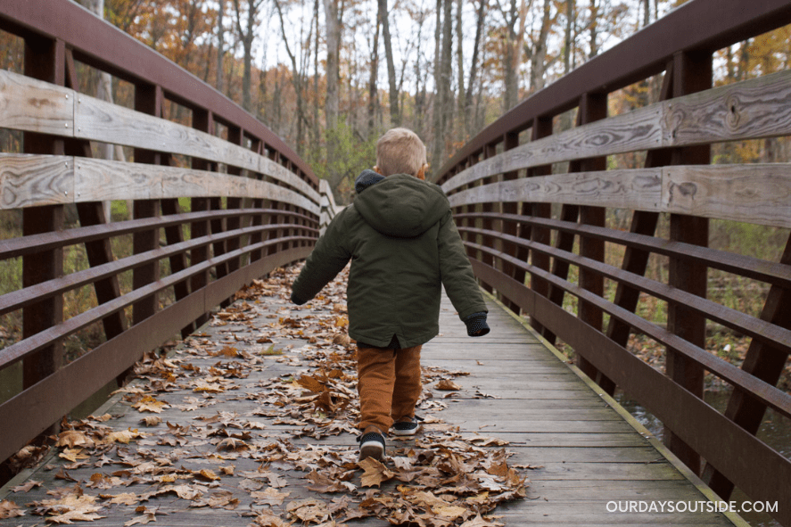 small boy walking on bridge - outdoor winter activities