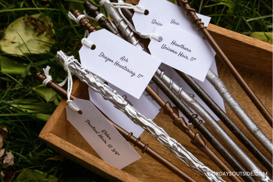 Several homemade wizard wands on display in a box - Harry Potter Party Ideas